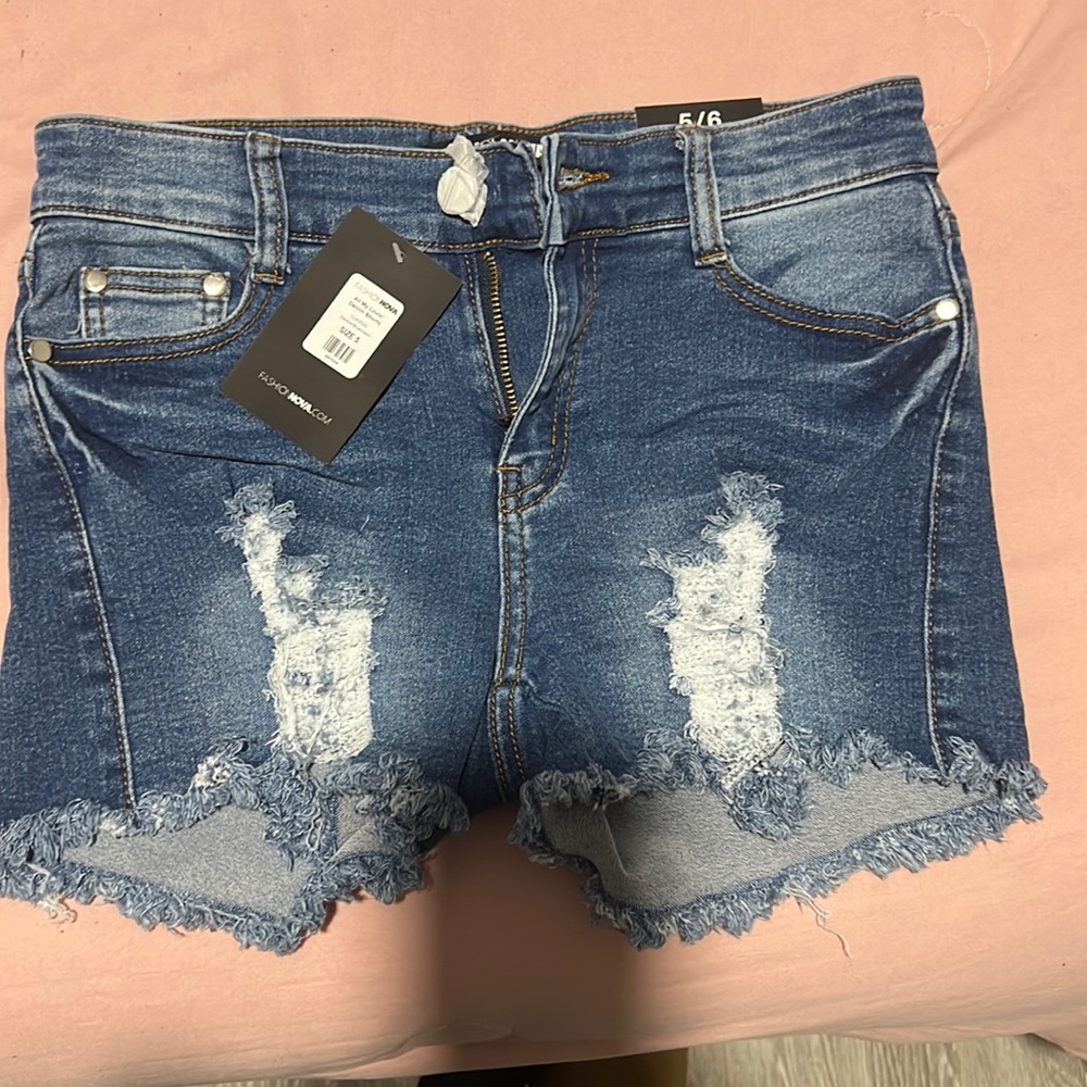 ripped Medium blue wash denim shorts